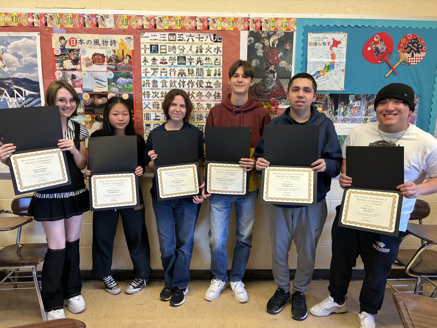 Students pose with their NJATJ Japanese Language and Culture Award certificates
